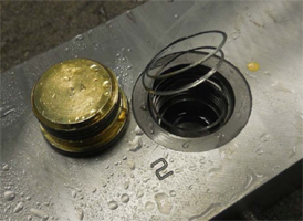 zero-leak gold plug beside port